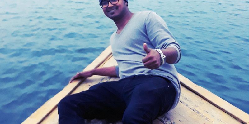 Happy male traveling on boat – free photo