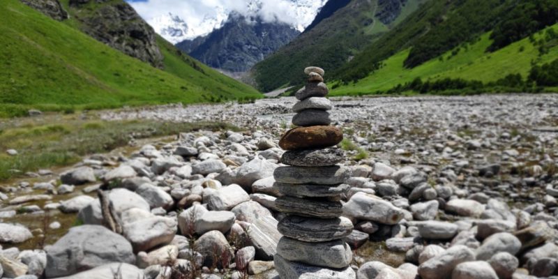 Stones stacked on lake shore – free photo